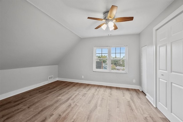 bonus room with light hardwood / wood-style floors, vaulted ceiling, and ceiling fan