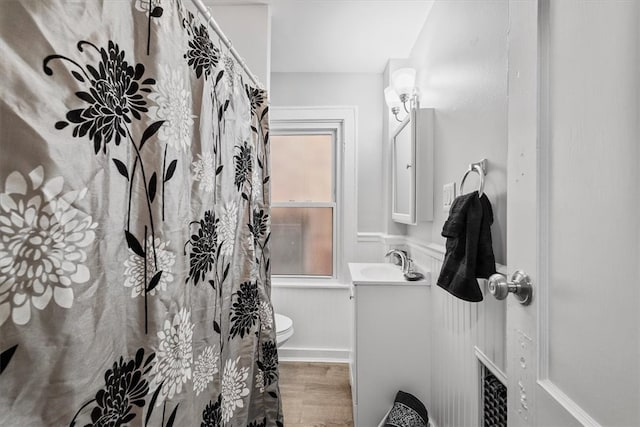 bathroom featuring a shower with shower curtain, vanity, toilet, and hardwood / wood-style flooring