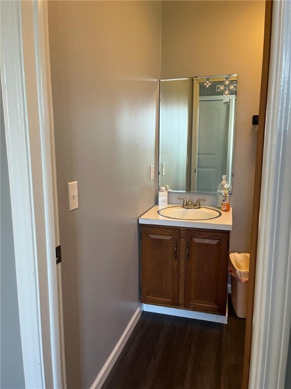 bathroom with vanity and hardwood / wood-style flooring