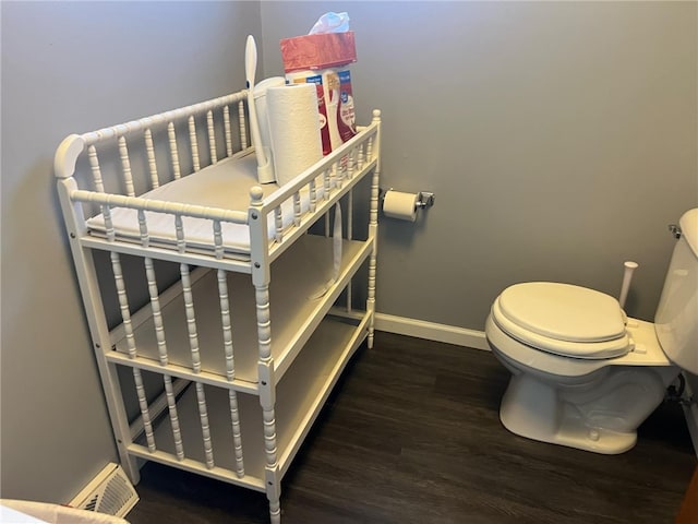 bathroom with hardwood / wood-style flooring and toilet