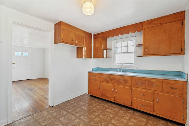 kitchen with light hardwood / wood-style floors and sink