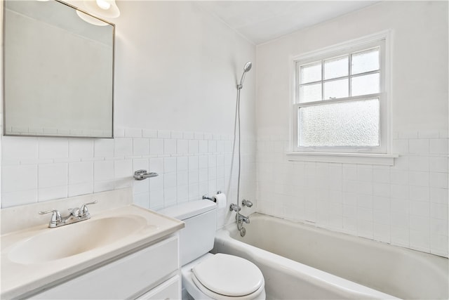 full bathroom with tile walls, bathtub / shower combination, vanity, and toilet