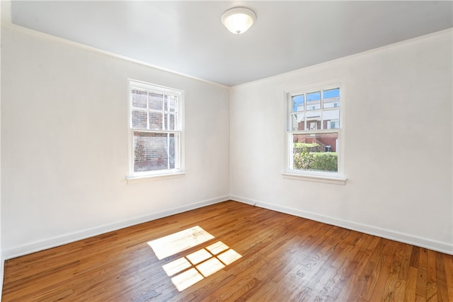 unfurnished room with crown molding and hardwood / wood-style floors