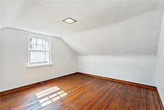 additional living space featuring lofted ceiling and hardwood / wood-style floors