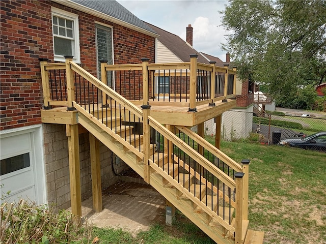 wooden deck featuring a yard