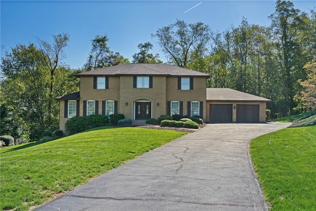 colonial house with a garage and a front lawn