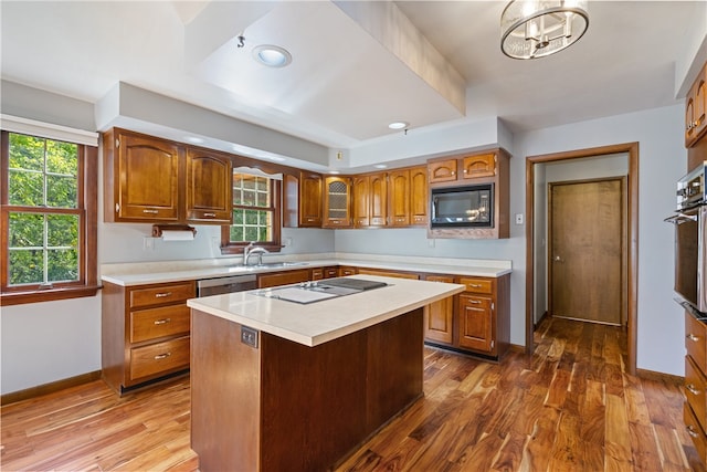 kitchen with a wealth of natural light, dark hardwood / wood-style floors, and black appliances