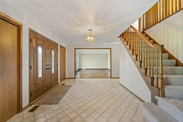 foyer entrance featuring a chandelier