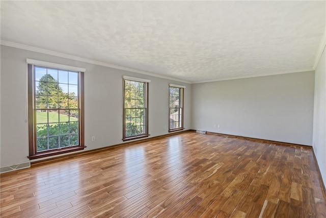 unfurnished room with wood-type flooring and crown molding