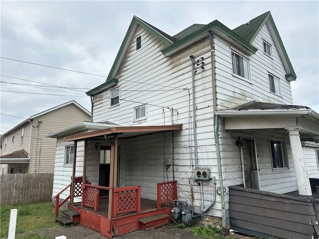 back of house featuring covered porch