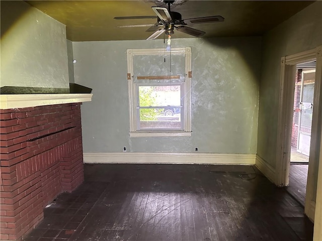 unfurnished living room featuring a fireplace, hardwood / wood-style floors, a ceiling fan, and baseboards