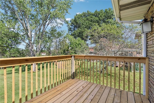 wooden terrace featuring a lawn