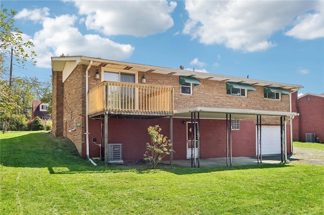 back of property featuring a garage, a balcony, a yard, and central air condition unit