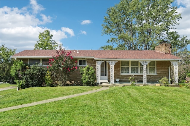 ranch-style house with a porch, a chimney, and a front lawn