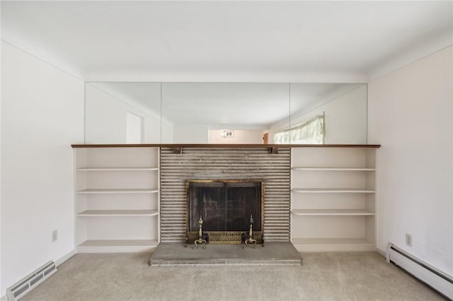 unfurnished living room featuring carpet floors and a baseboard heating unit