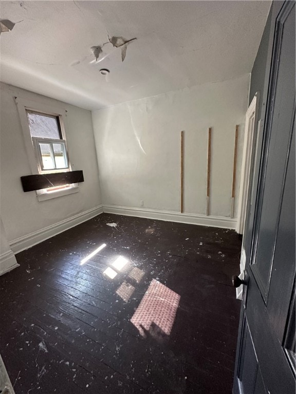 unfurnished room featuring dark hardwood / wood-style flooring