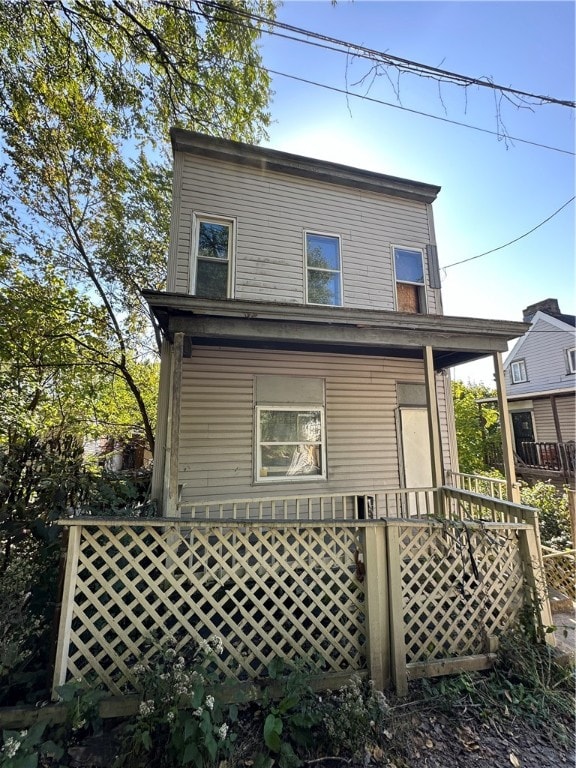 back of property with covered porch