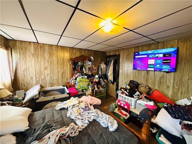 bedroom featuring hardwood / wood-style floors and wooden walls