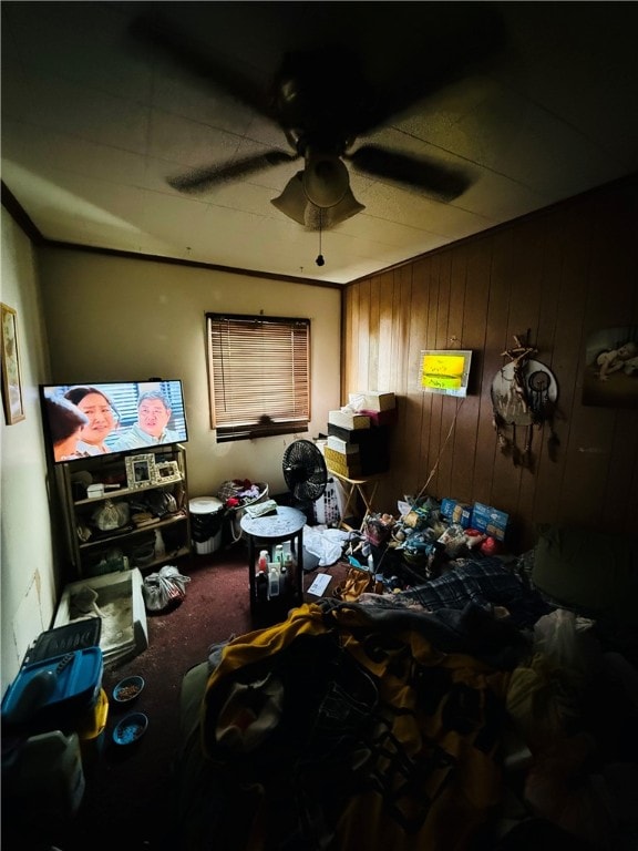 miscellaneous room featuring carpet flooring, ceiling fan, and wooden walls