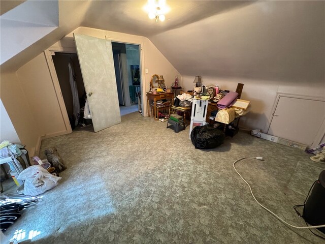 bonus room with lofted ceiling and light colored carpet