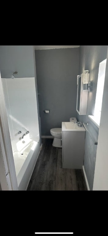 bathroom with hardwood / wood-style floors, toilet, and vanity