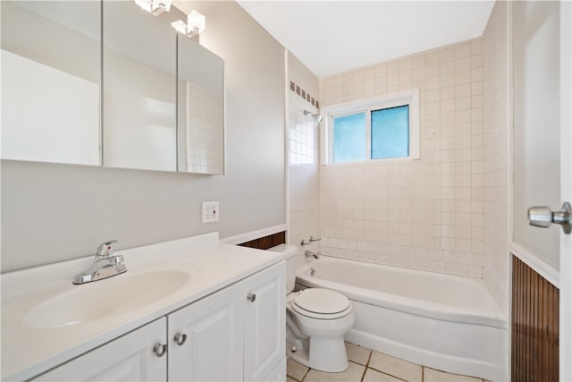 full bathroom featuring tile patterned floors, vanity, toilet, and tiled shower / bath combo