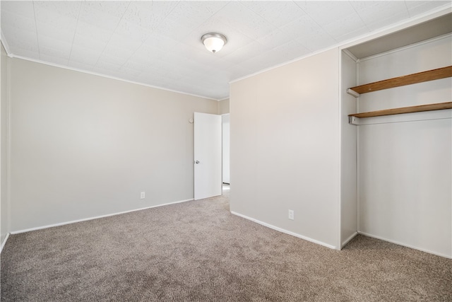 unfurnished bedroom featuring crown molding, carpet floors, and a closet