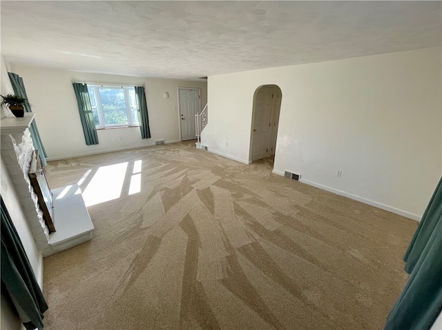 carpeted empty room with a textured ceiling