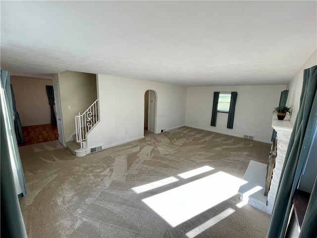 unfurnished living room with light carpet