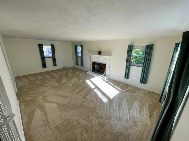 unfurnished living room with light colored carpet