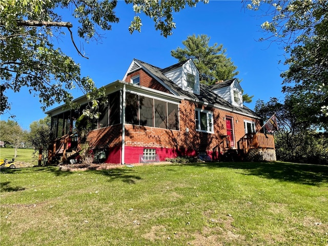 view of side of home with a yard and a sunroom