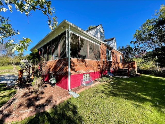 view of property exterior with a sunroom, a lawn, and a deck