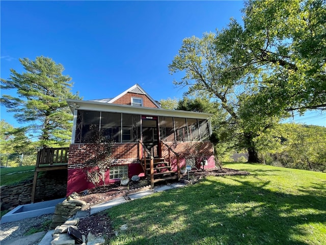 back of house with a yard and a sunroom