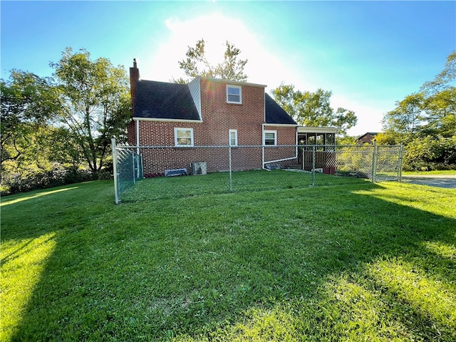 rear view of house featuring a yard