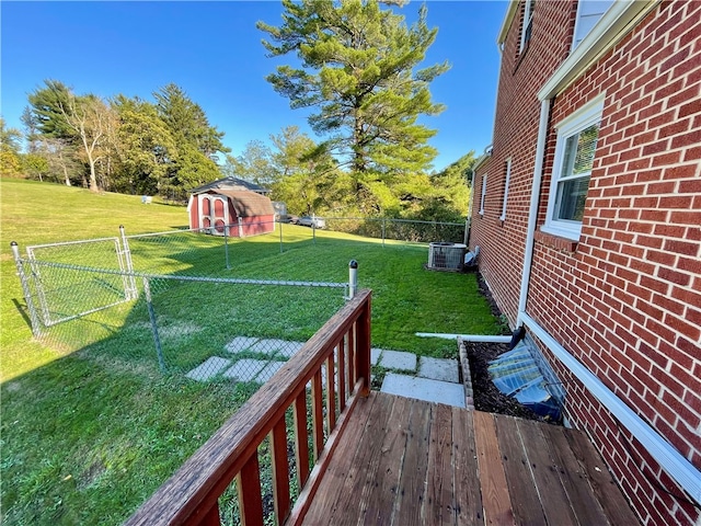 view of yard featuring central AC unit and a storage shed