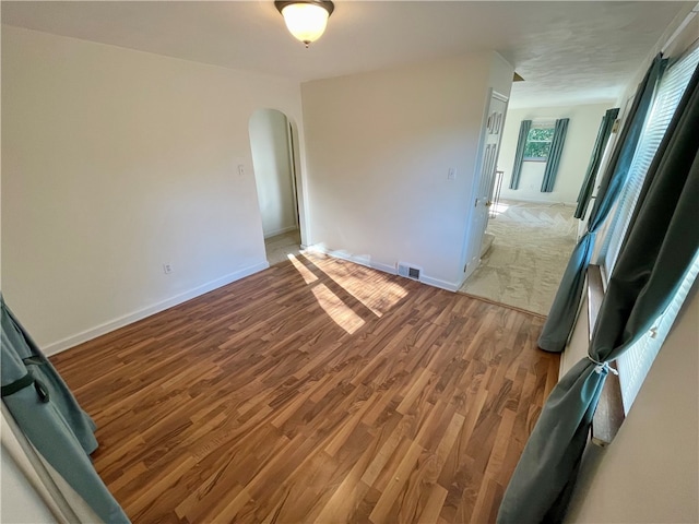 empty room with hardwood / wood-style flooring