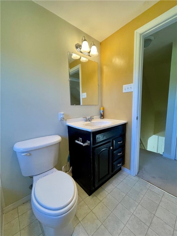 bathroom featuring tile patterned floors, toilet, and vanity