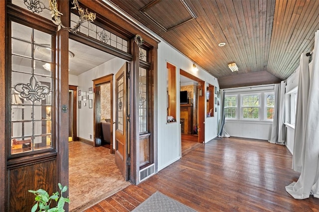 hall featuring vaulted ceiling, wood-type flooring, and wooden ceiling