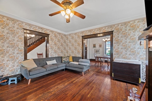 living room featuring ornamental molding, ceiling fan, and dark wood-type flooring