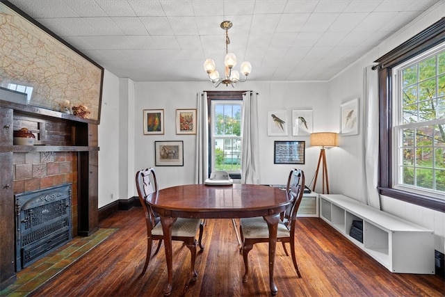 dining room featuring dark wood-type flooring, crown molding, and a wealth of natural light