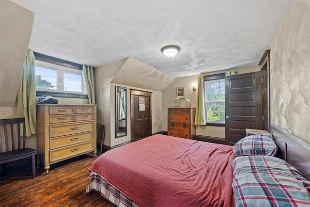 bedroom with dark wood-type flooring and vaulted ceiling