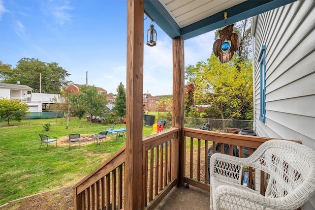 wooden deck featuring a lawn