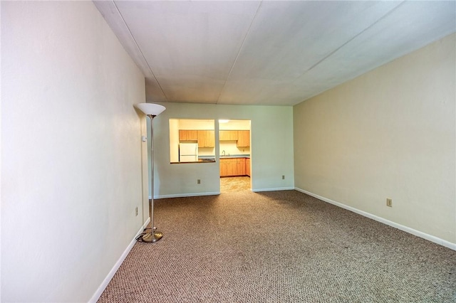 416 Isabella St Unit 404, Oakmont, PA 15139 - unfurnished living room with carpet flooring, baseboards, and a sink