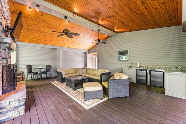 wooden terrace with outdoor lounge area, an outdoor kitchen, and ceiling fan