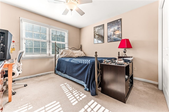 bedroom featuring a closet, light carpet, and ceiling fan