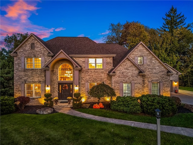 front of property with french doors and a lawn