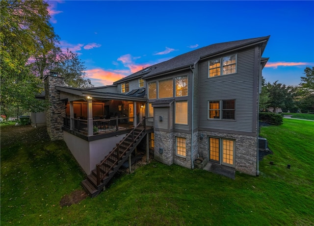 back house at dusk with a yard