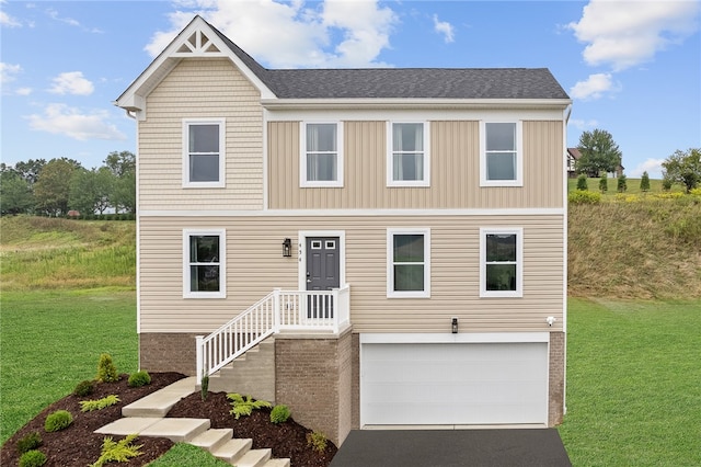 view of front facade with a front lawn and a garage