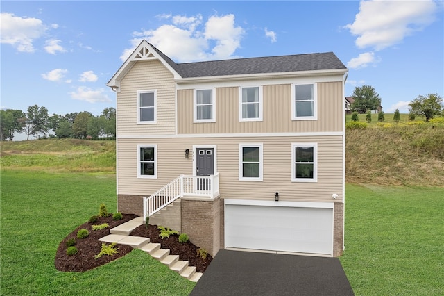 view of front of property with a front yard and a garage