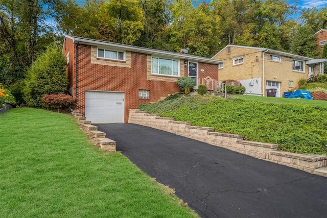 view of front of property with a front yard and a garage